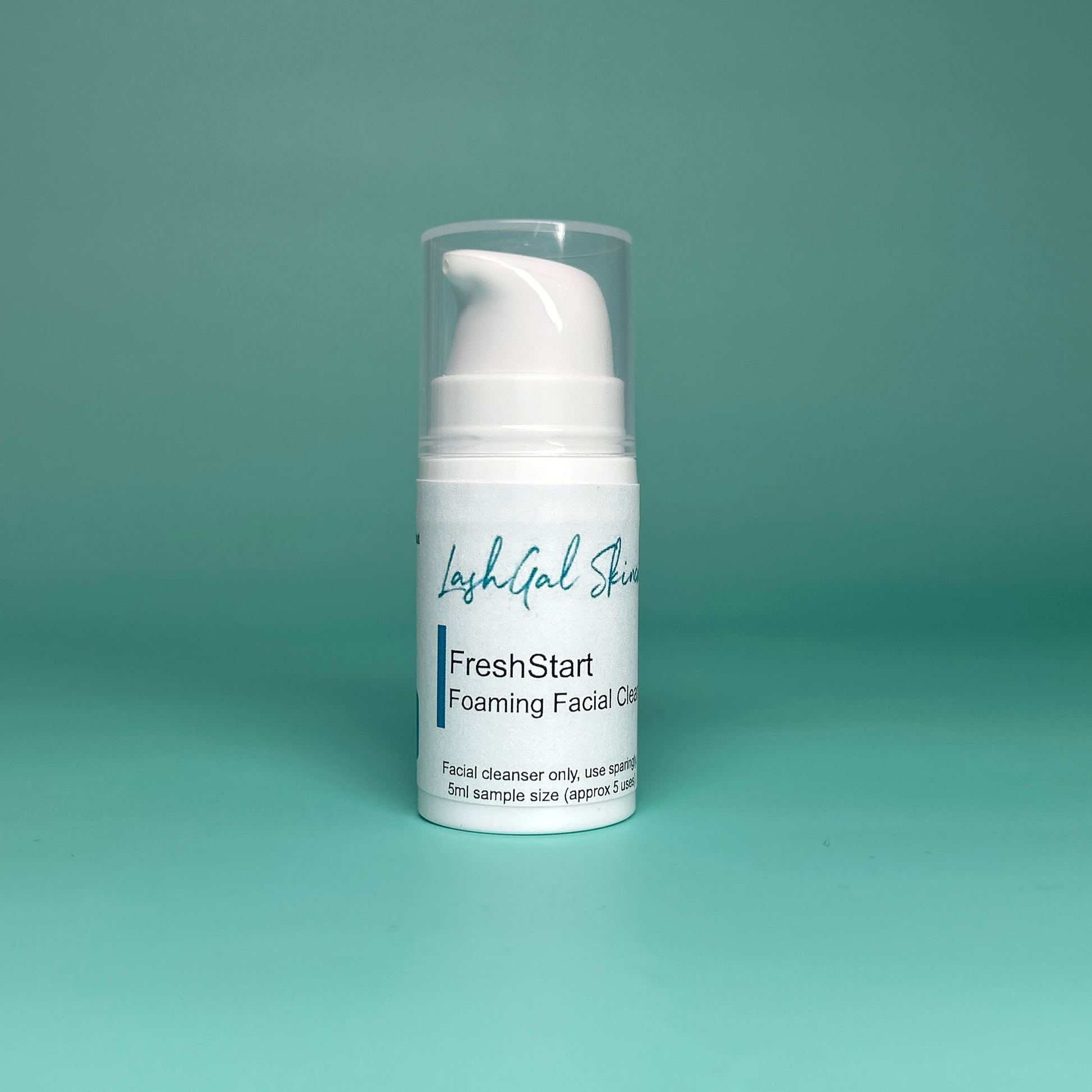 sample size White facial cleanser bottle with pump on a teal background